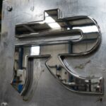 chrome logo on metal plate